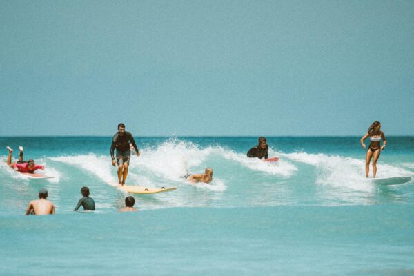 Surfers riding thrilling waves in Honolulu, Hawaii, showcasing vibrant surf culture.